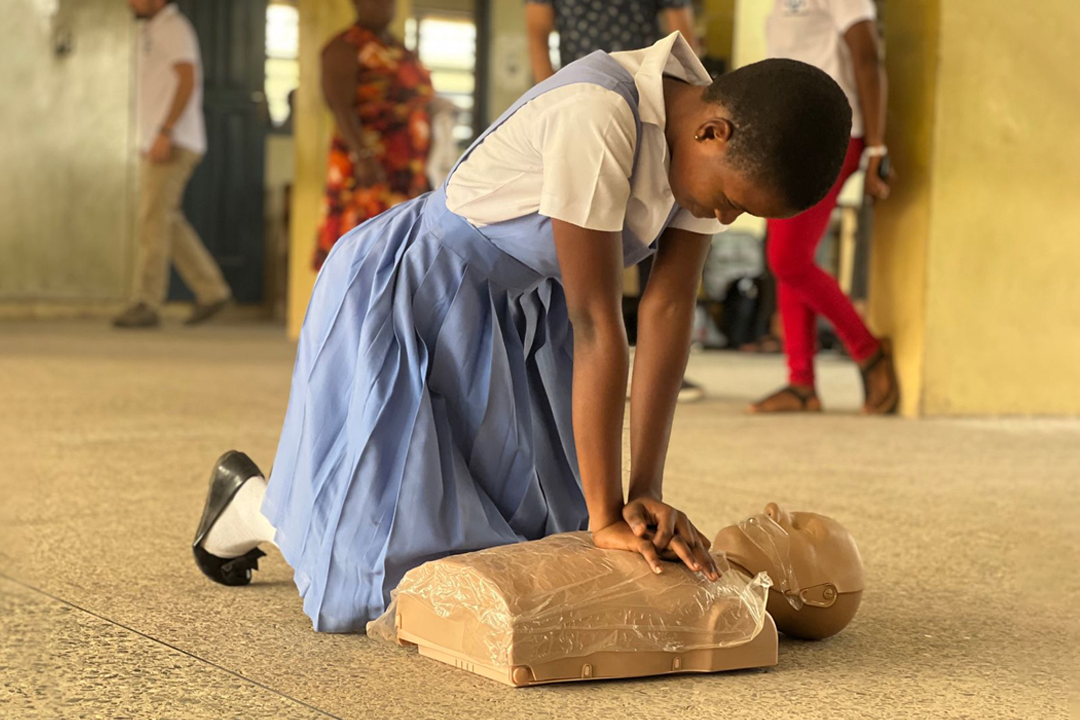 Woman practicing CPR on dummy