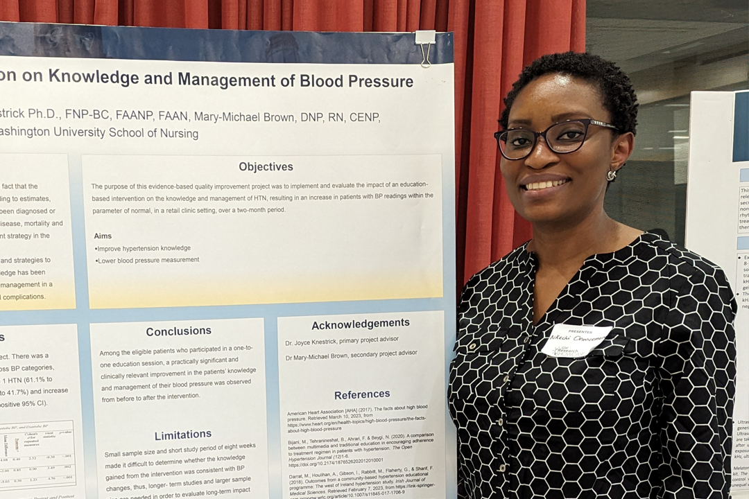 Nkechi posing with poster