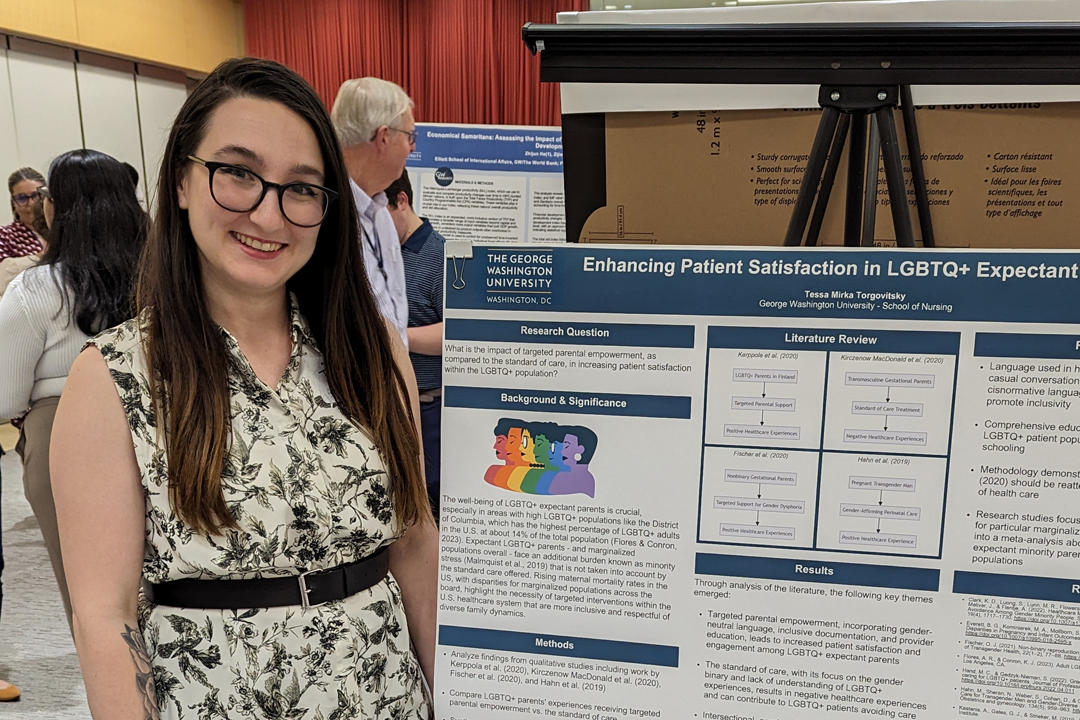 Tessa Mirka Torgovitsky posing with her poster