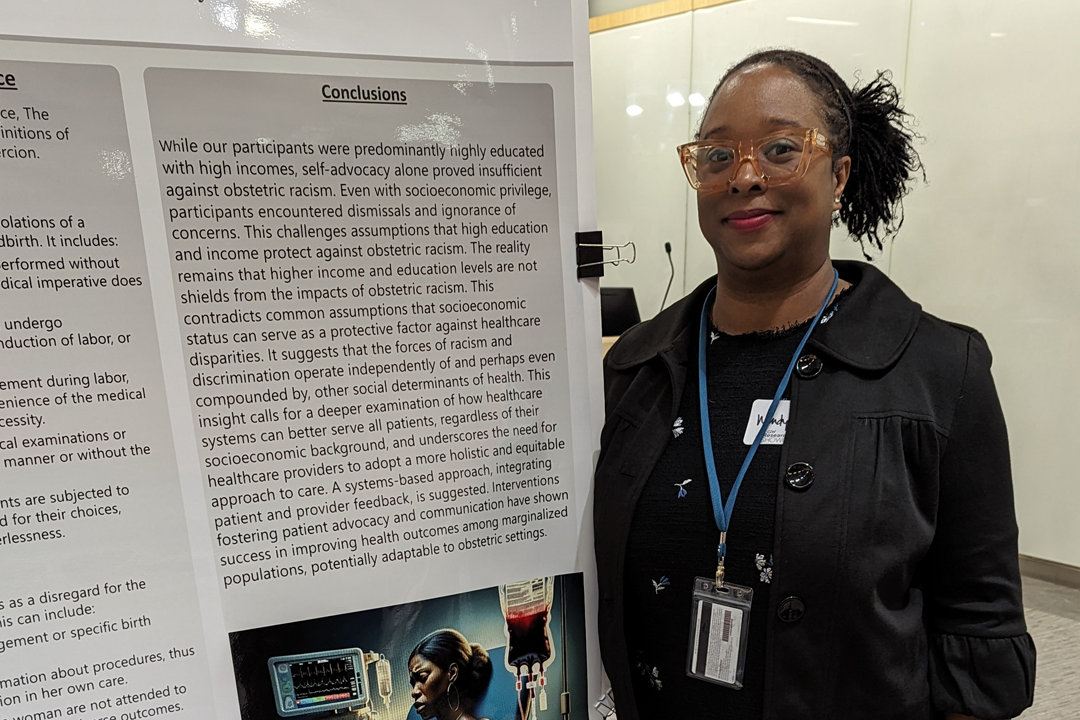 Wendy Post posing with her poster