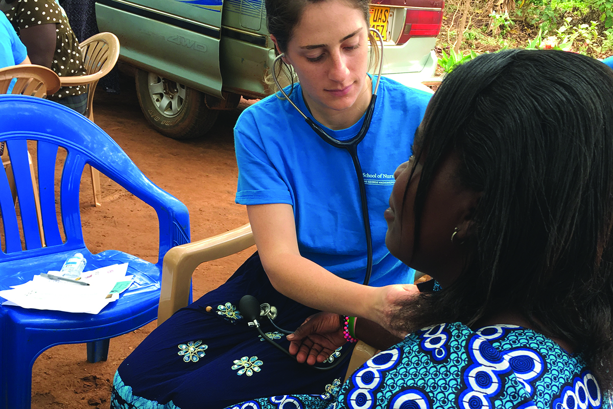 gw student working with patient in Uganda