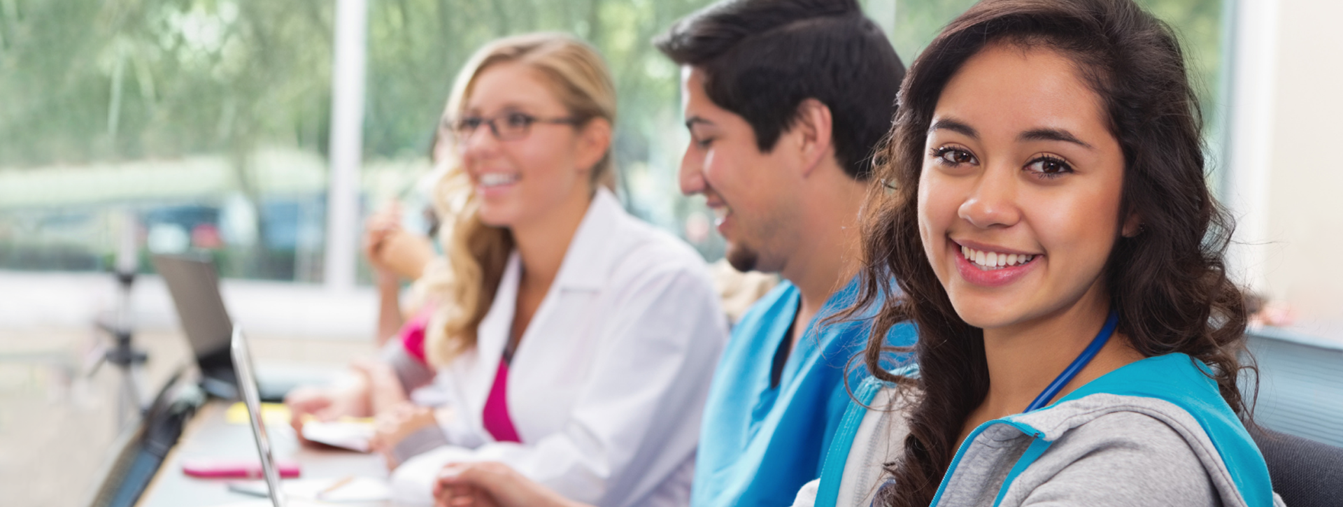 nursing students at laptops in classroom